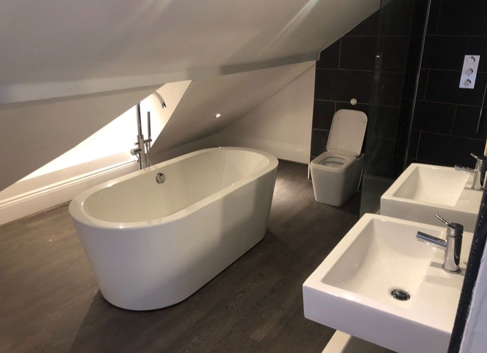 New bathroom installation featuring freestanding bath in modern home renovation
