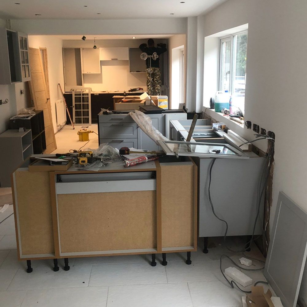Kitchen renovation in progress showing cabinet installation and construction work