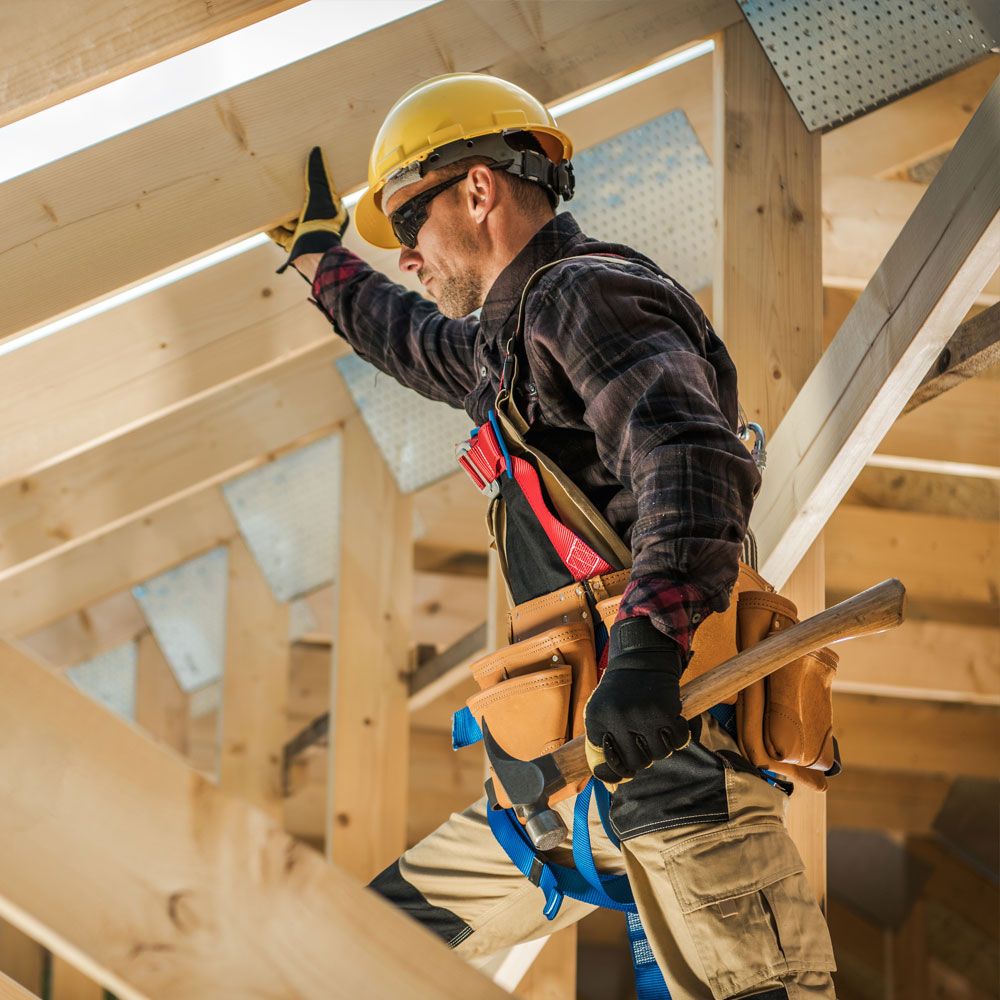 Professional carpenter installing loft trusses during loft conversion in Solihull